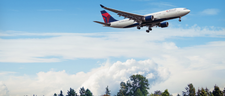 A330-200 in flight over trees