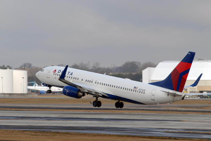 A 737-800 taking off into a gray sky.