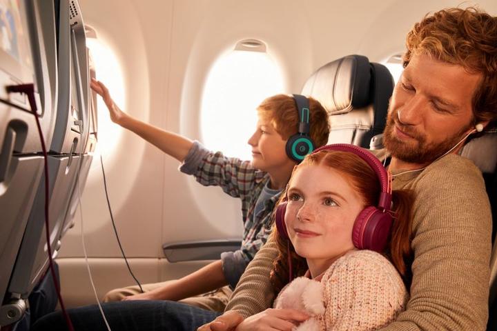 Delta customers enjoying in-flight entertainment