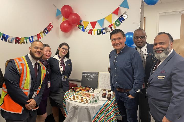 Todd O. celebrates achieving 14 Million Miler Status with Delta people at John F. Kennedy International Airport (JFK).