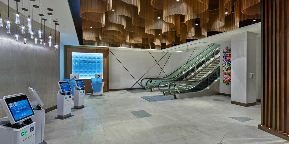 Once checked in, guests will ascend the monumental staircase or escalators, passing beneath dazzling ceiling fixtures modeled after ocean waves before arriving at the custom wood-screened area that marks the Club’s entrance.