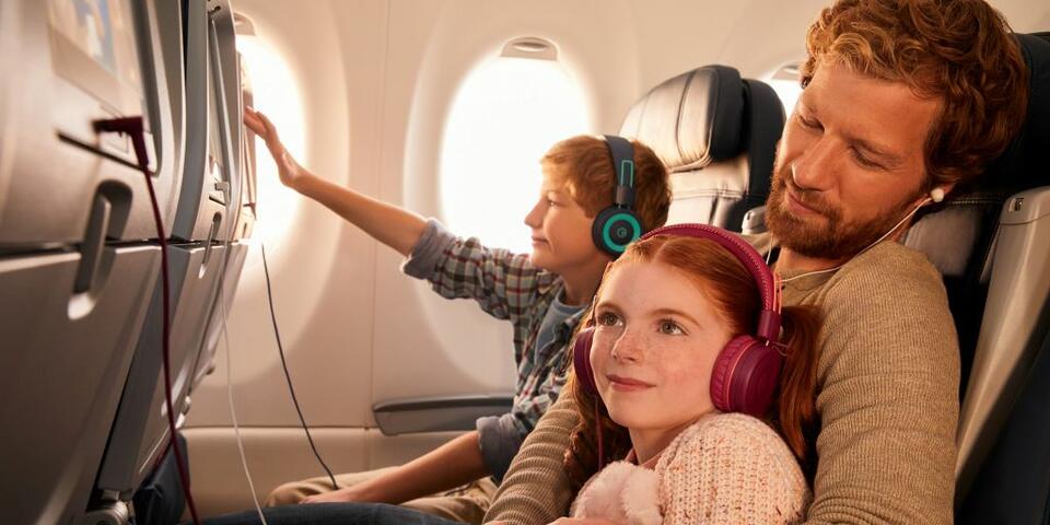 Delta customers enjoying in-flight entertainment
