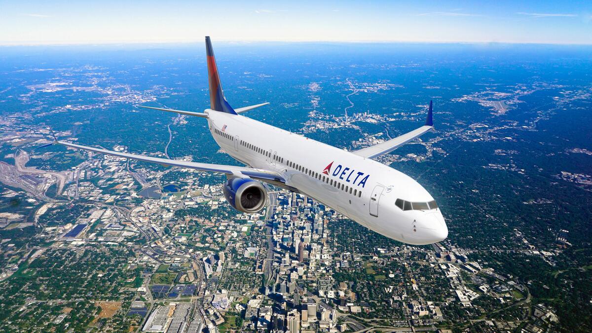 Boeing 737-10 MAX in flight over city