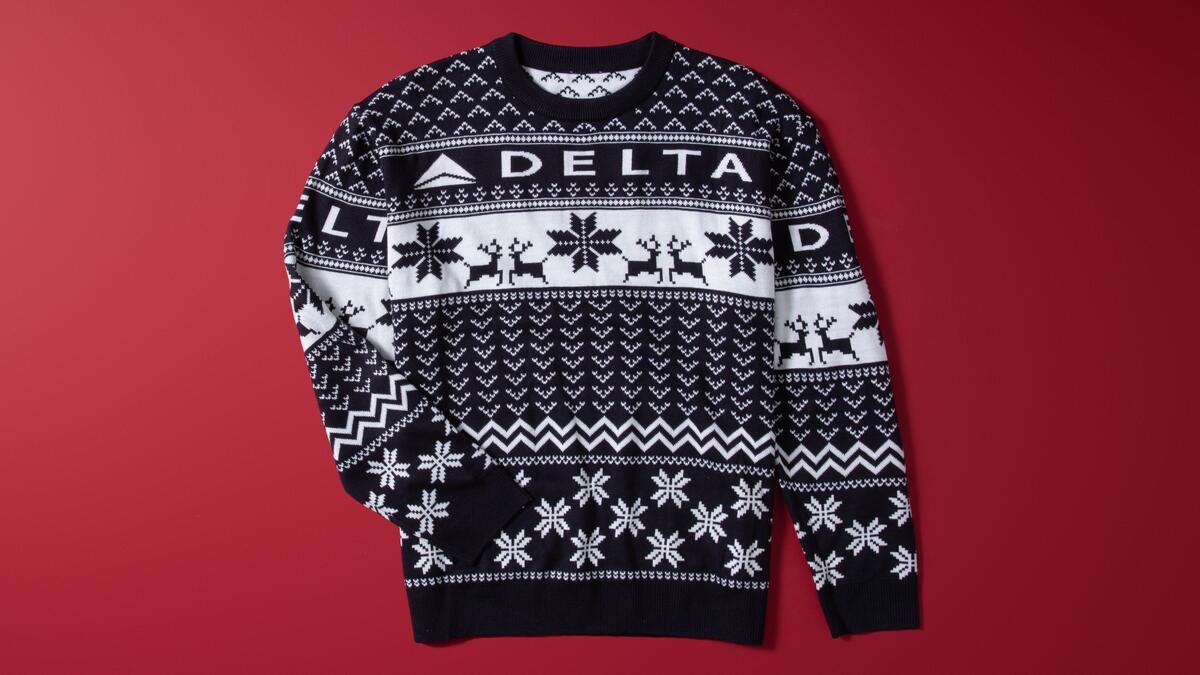 Show off your love for travel this winter with our Navy Delta Holiday Sweater. Cozy and colorful, this sweater is perfect for any festive occasion. 